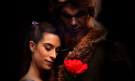 Beauty and The Beast holding a red rose