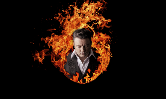 Johnny Cash (tribute) stands within a ring of fire