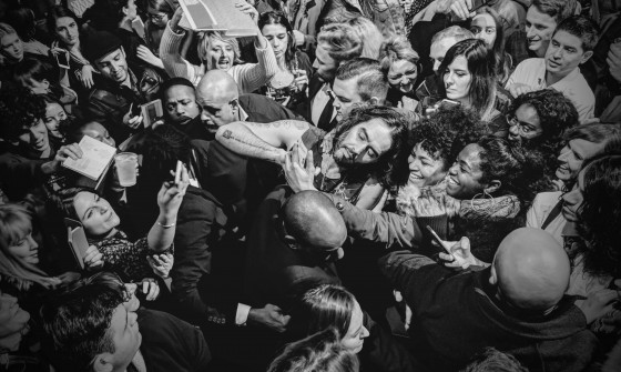 Russell Brand makes his way through a busy crowd of fans.