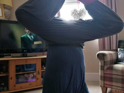 Ben stands on his head doing a traditional yoga pose.
