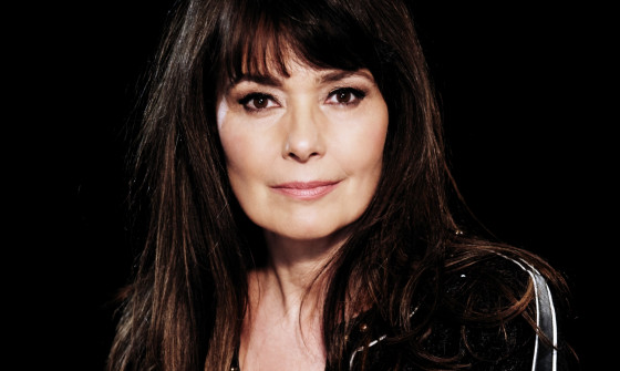 Beverley Craven looks into the camera in front of a black background.
