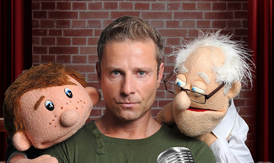 Paul Zerdin holds two of his puppets