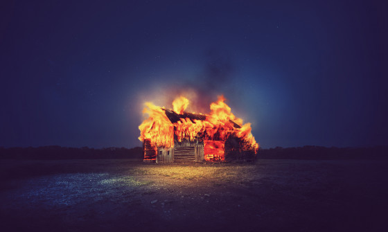 A red barn is on fire
