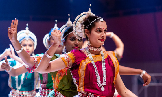 Odissi performers on stage in a line