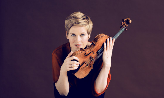 Isabelle Faust holding her violin
