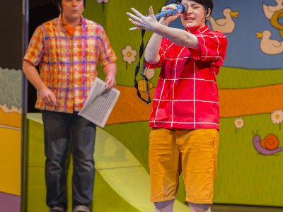 A cast member looks through a telescope