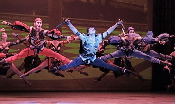 A group of dancers jump in the air