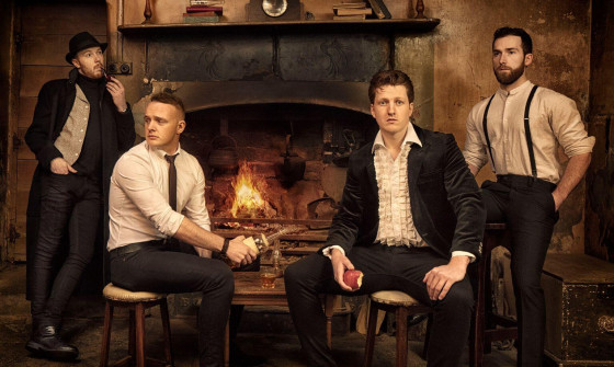 JigJam sit in formal dress in front of a fireplace