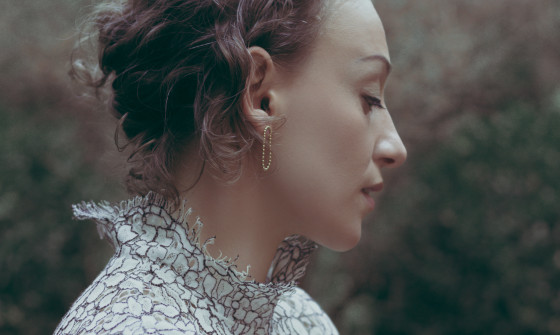 Ana Silvera stands in a woodland in this washed out photograph