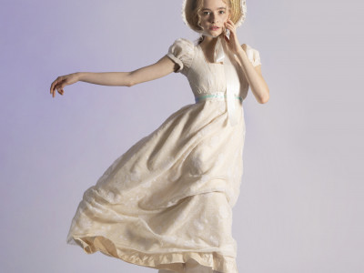 Margaret strikes a pose as she dresses in white period dress