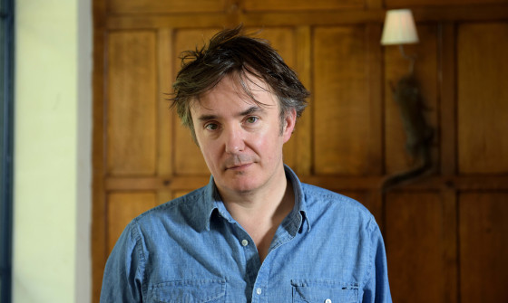 Dylan Moran looking at the camera from waist up