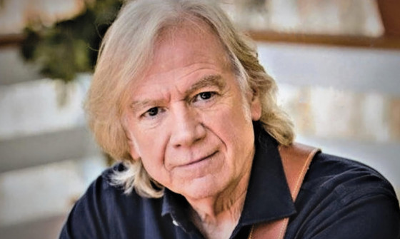 Close-up of Justin Hayward smiling towards the camera