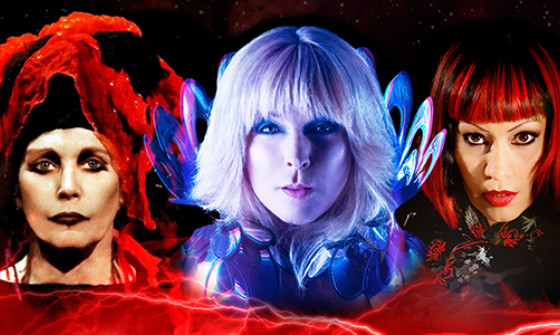 Close-up of Toyah, Lene Lovich, and Saffron of Republica all facing the camera with red and blue lighting effects