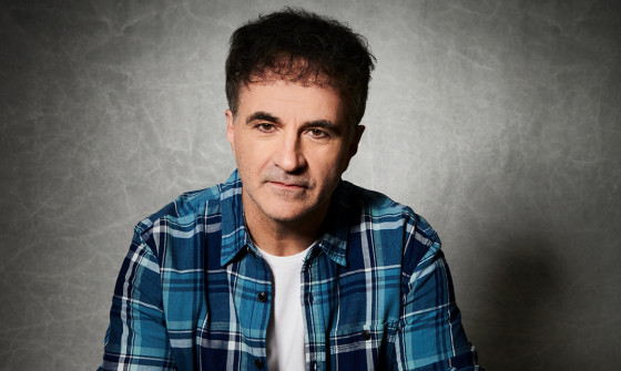 Noel Fitzpatrick looking into the camera wearing a blue shirt on a neutral background